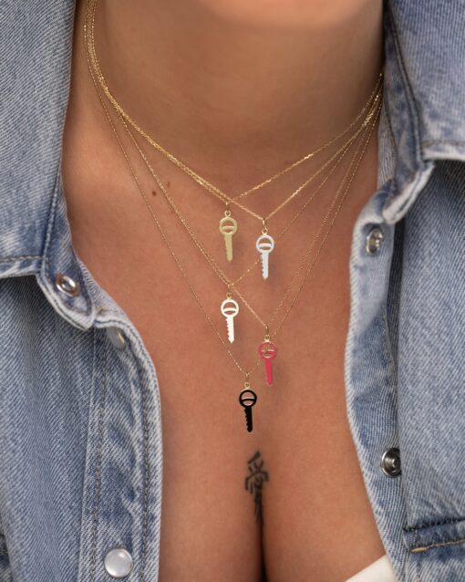 a woman wearing a denim jacket with a necklace